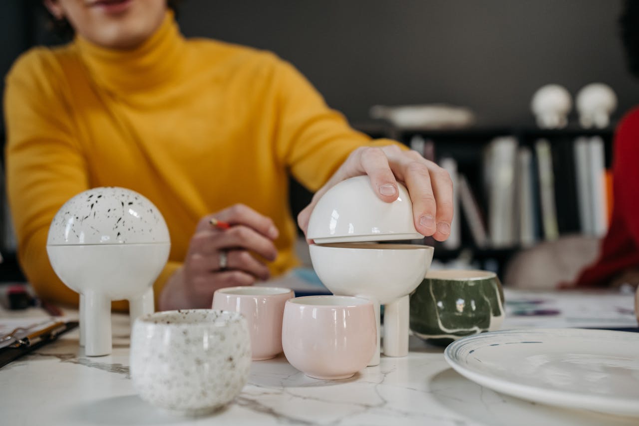 A creative pottery setup with modern designs featuring teacups and decorative items in a studio.